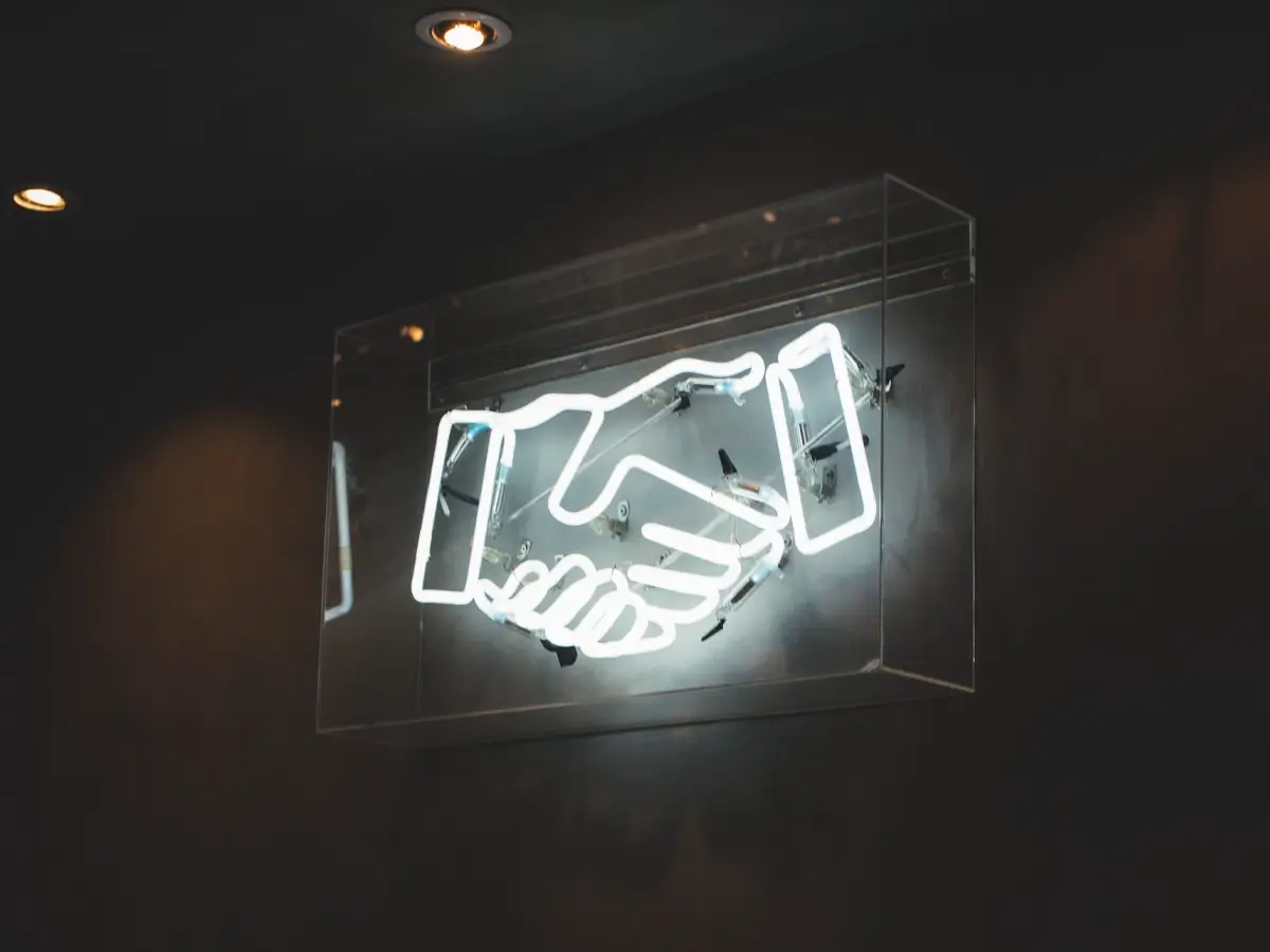 clickfaktory web design neon handshake sign
